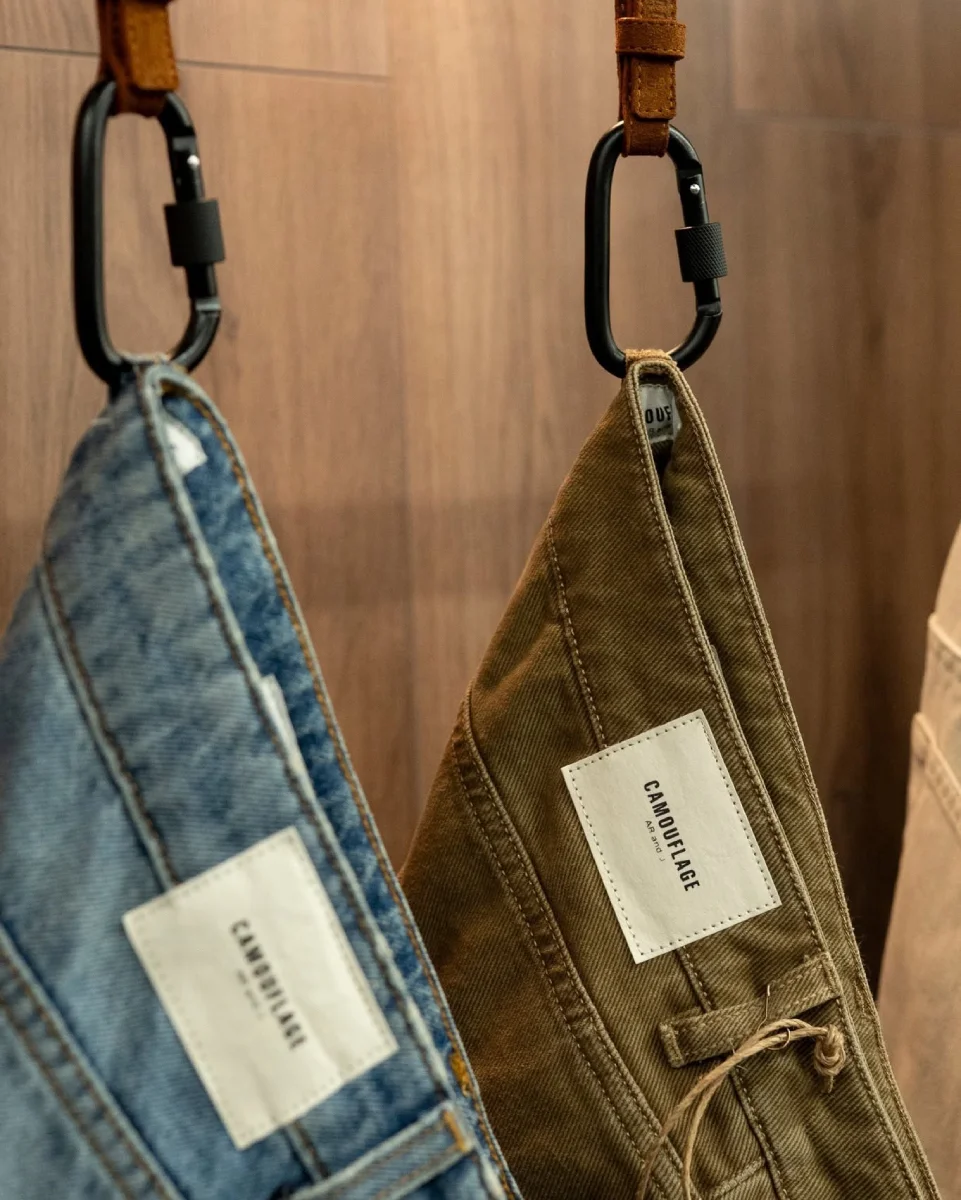 Camouflage denim jeans with branded hang tags and premium finishing