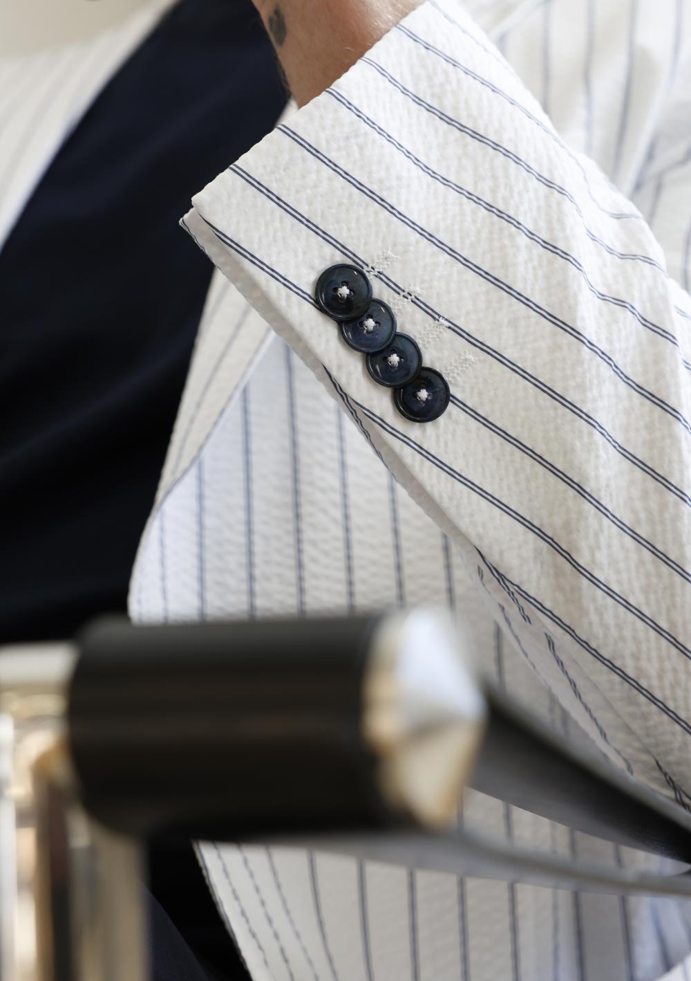 Close-up of Olliver Grey pinstripe jacket sleeve and button detail