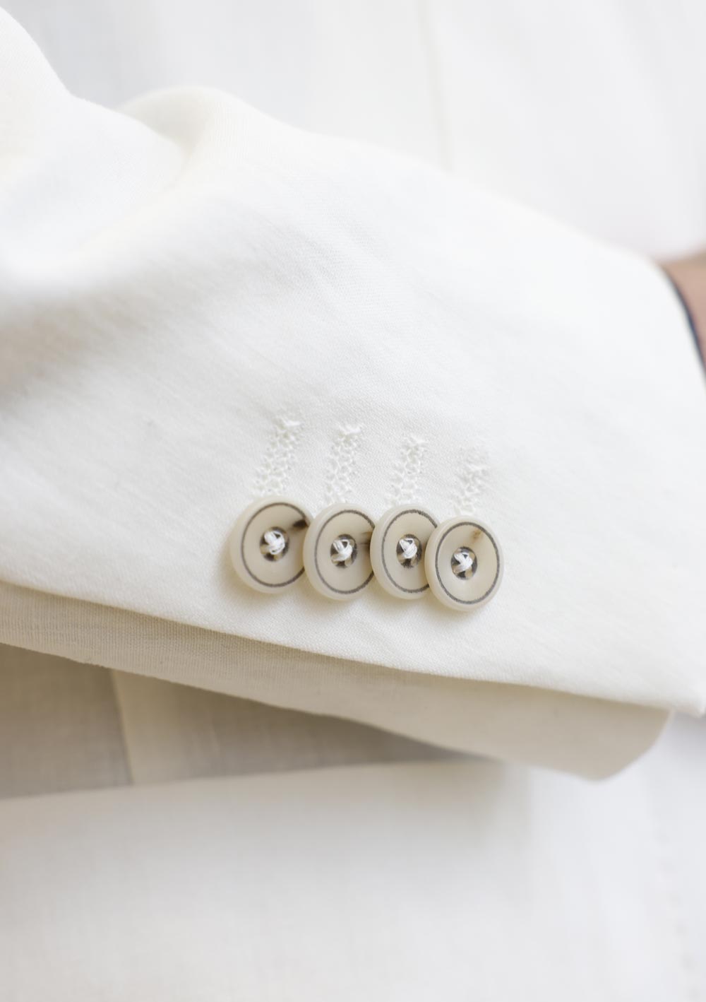 Close-up of Olliver Grey white dinner jacket sleeve buttons