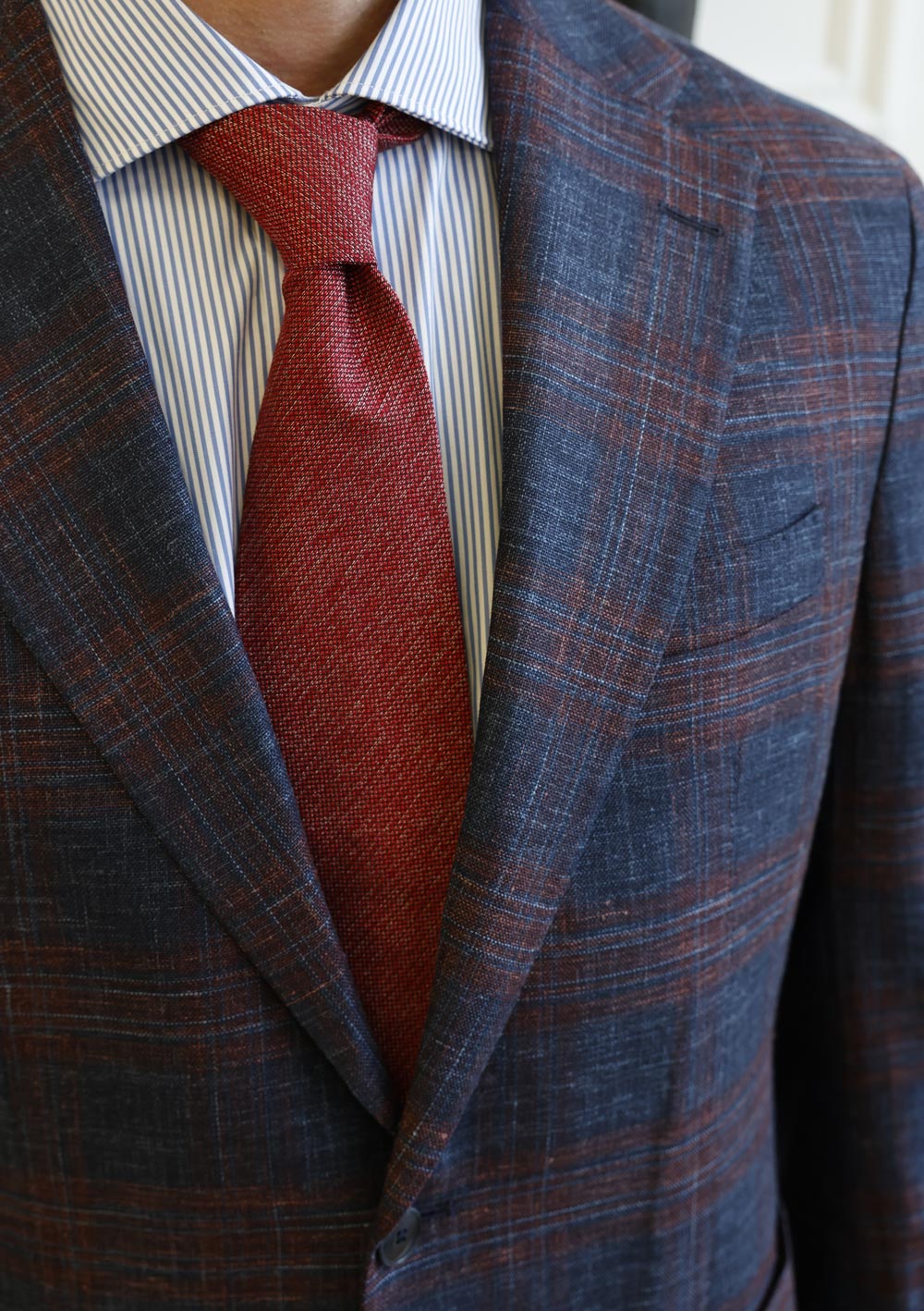Close-up of Olliver Grey blue plaid sport coat with red tie