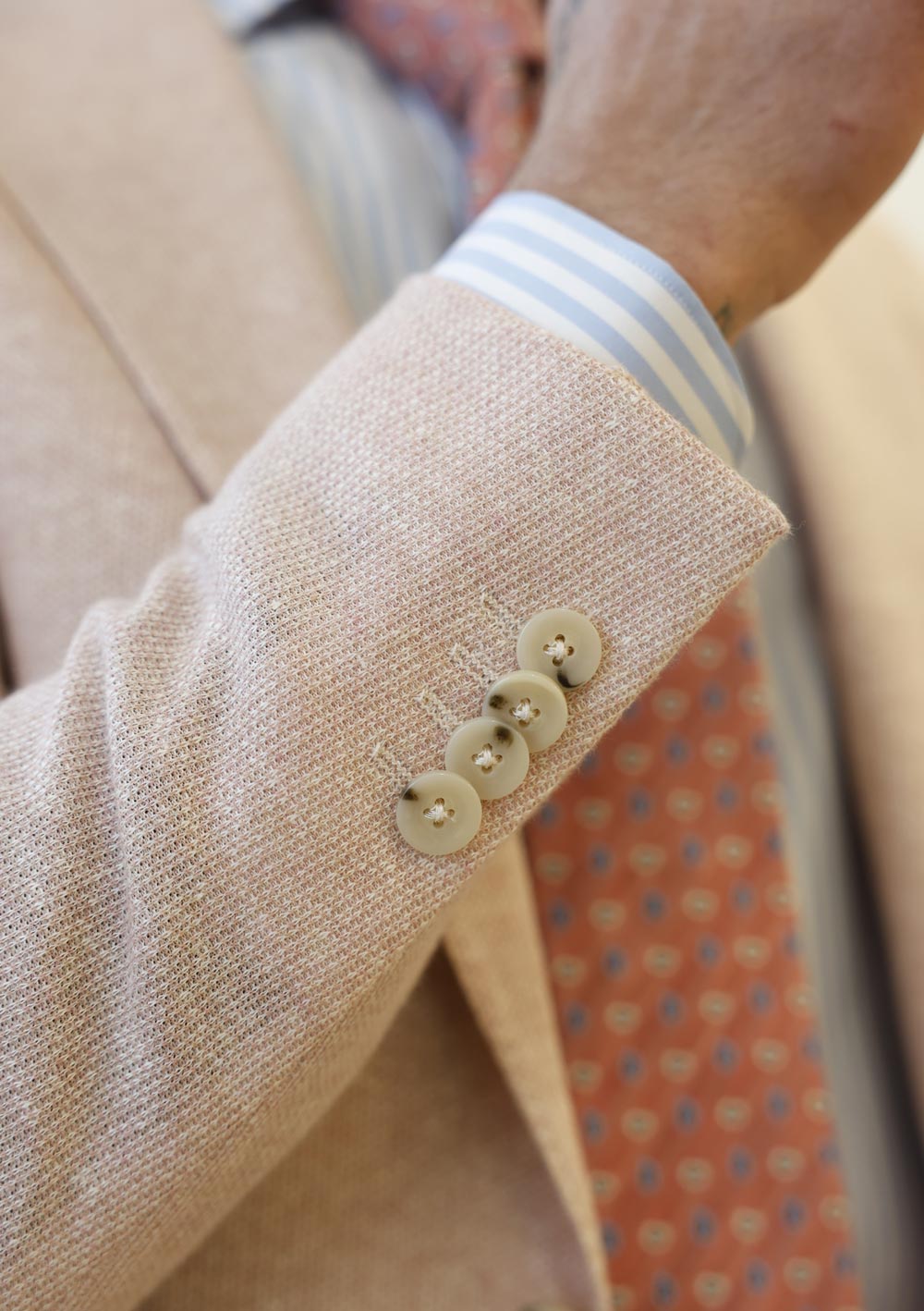 Close-up of Olliver Grey beige sport coat sleeve with decorative buttons