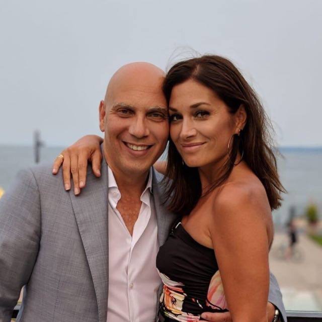 Picture of John and Anna Greco posing in front of a body of water.